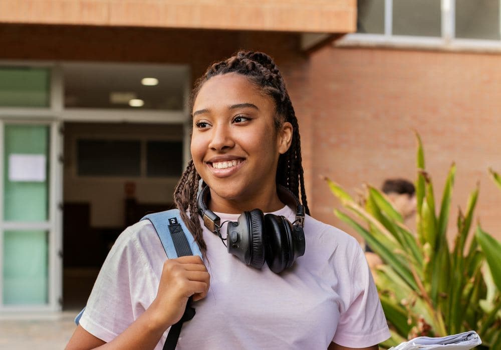 Jordan P., a Gettysburg student carrying books across campus